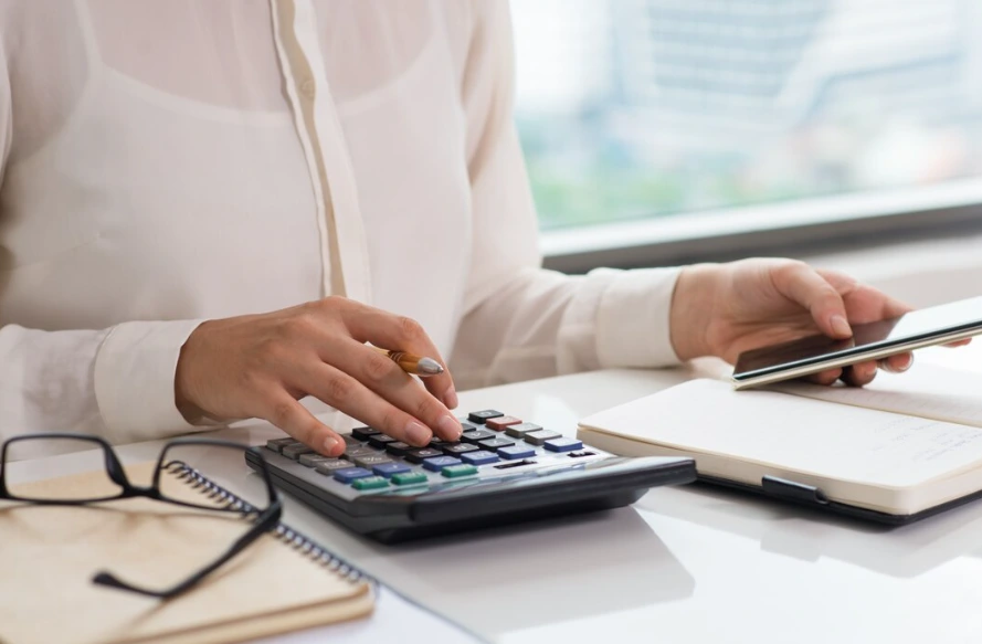 Woman using calculator